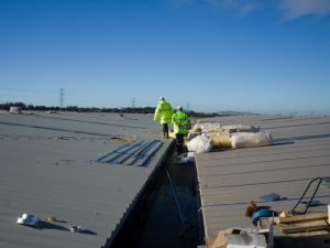 H. Kulak & Son team inspecting commercial roofing drainage systems in Southington, CT