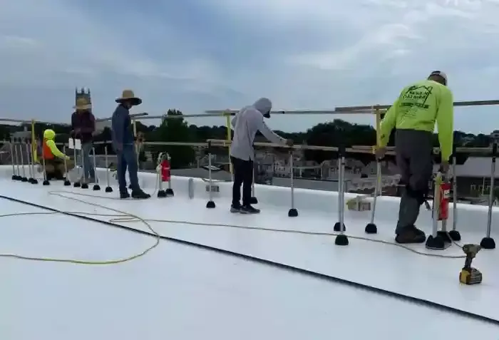 H.Kulak & Son contractors working on white commercial rooftop in Connecticut